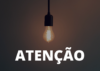 Imagem contém pendente preto com lâmpada acesa. Abaixo está a palavra atenção.