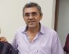 Servidor Aureliano Carvalho sorridente veste camisa clara
